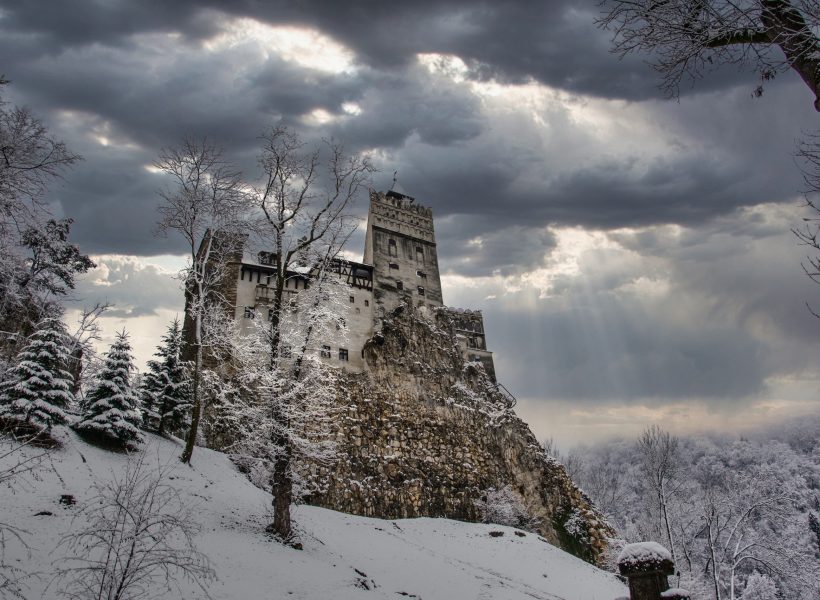 Stock photo of Bran Castle, located in Transylvania, Romania. Dracula's Bran. Dramatic Image Of A Medieval Castle With A Snowy Background. Travels and tourism.