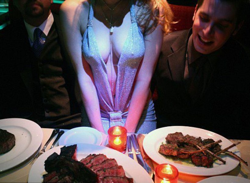 Dinner party with candlelit steaks, elegant attire, and a vibrant atmosphere. Perfect for fine dining and nightlife experiences.