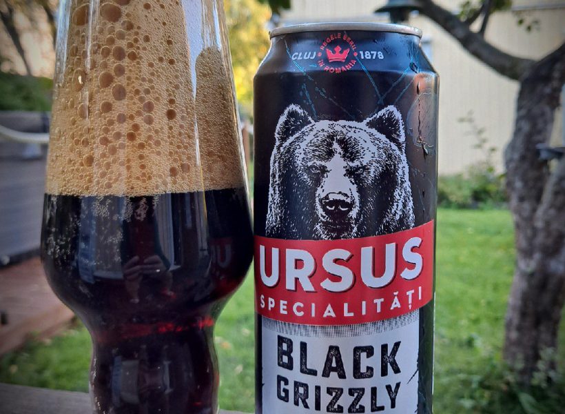Romanian Beer Tasting 2 A can of Ursus Black Grizzly beer with a dark ale in a glass outdoors, featuring 6% alcohol content.