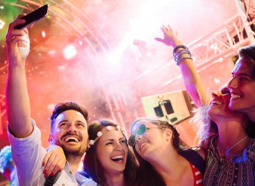 Cheerful friends partying in club at night