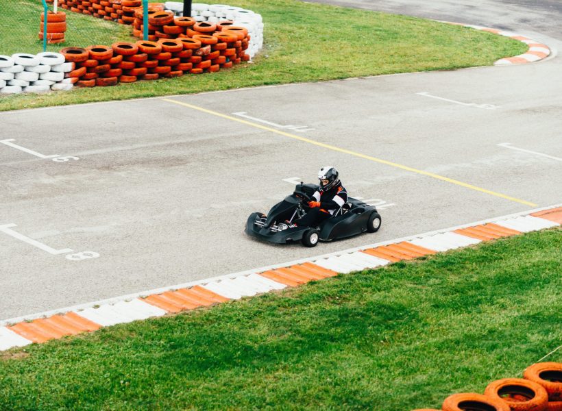 Woman driving go-cart on a sports track